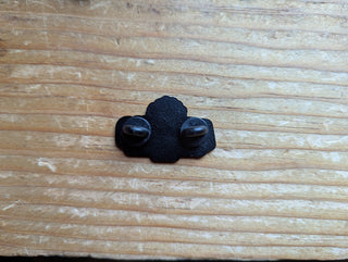 Back of the Armeno Logo enamel pin. Black metal with two black backings covering the sharp points of the pin.